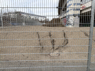 foto von eine, kleinen abhang der von mini-erosionen durchzogen ist, das wasser hat sich den weg zu einem gulli durch den sand gegraben