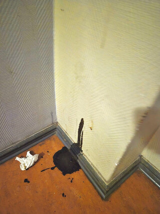 foto eines menschlichen kackhaufens, der nicht nur auf dem boden liegt, sondern auch ein bisschen an der wand klebt.