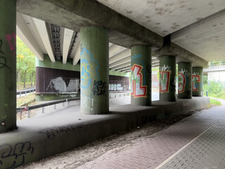 unterführung unter der A111 am hermsdorfer damm, im vordergrund die runden, bemalten stützen der autobahnbrücke.