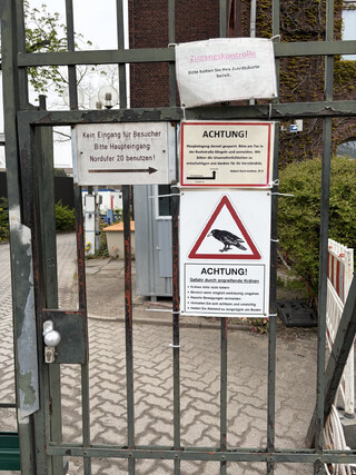 foto vom gesperrten eingang des robert-koch-instituts am nordufer mit diversen warnungen und hinweisen